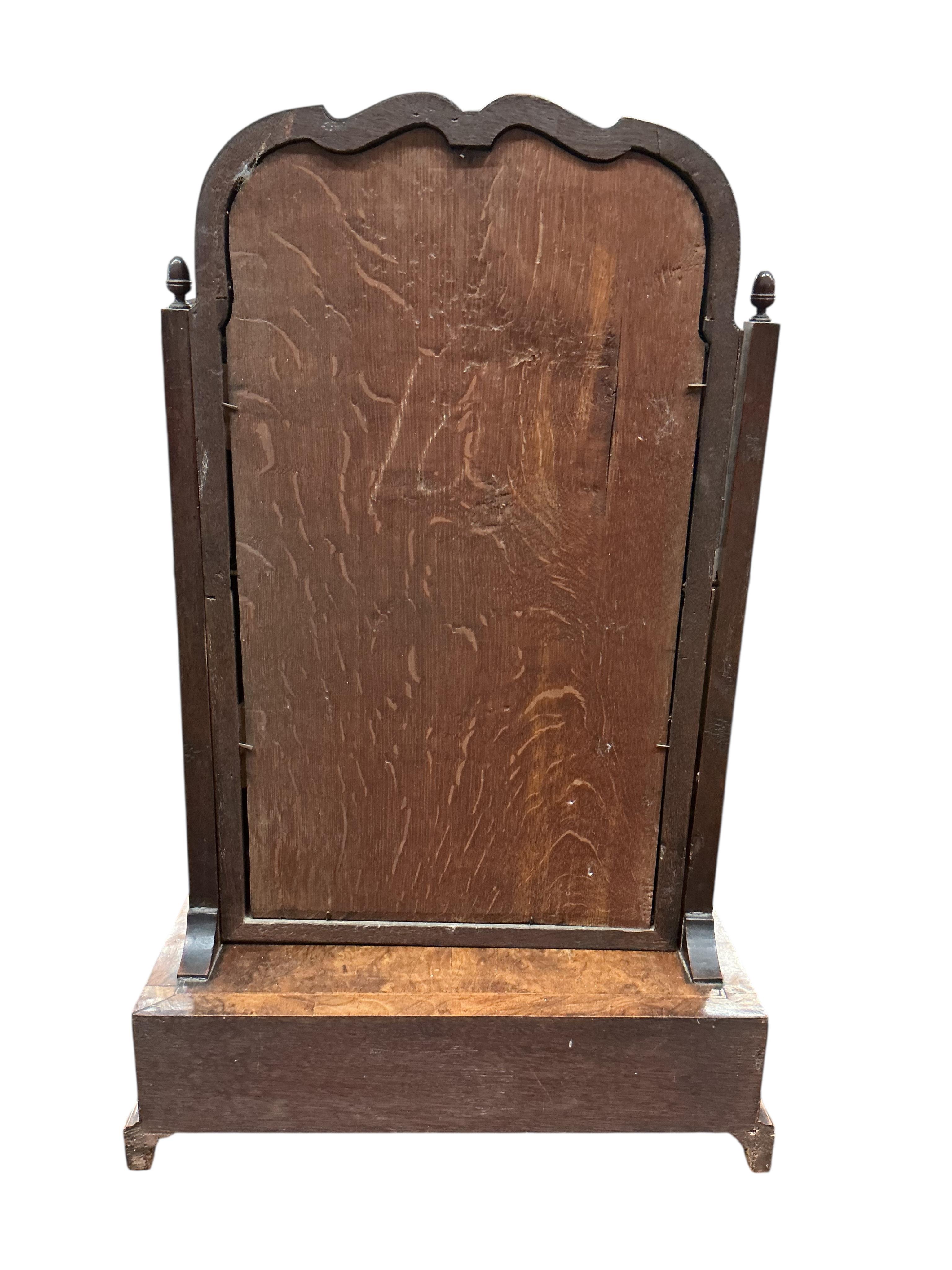An early 18th century feather banded walnut toilet mirror, with three base drawers, width 44cm, depth 24cm, height 68cm